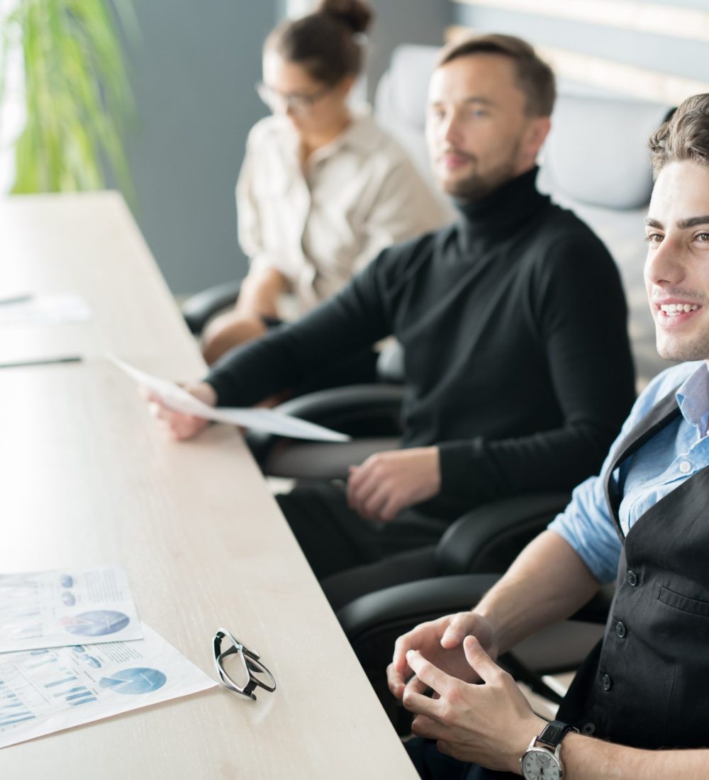 Group of smiling businesspeople meeting on presentation in office